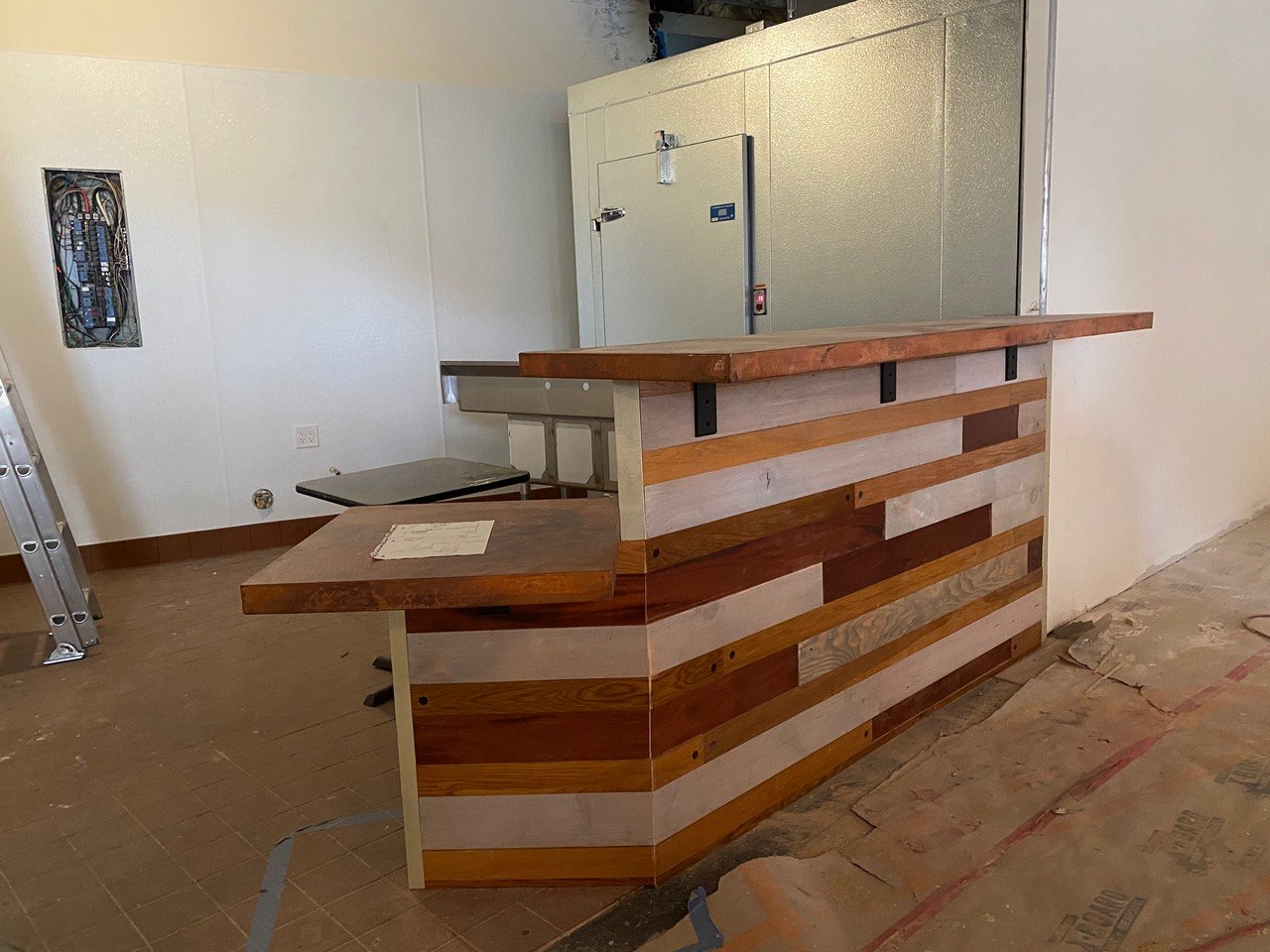 Commercial build-out with a custom reclaimed-wood bar and reception counter