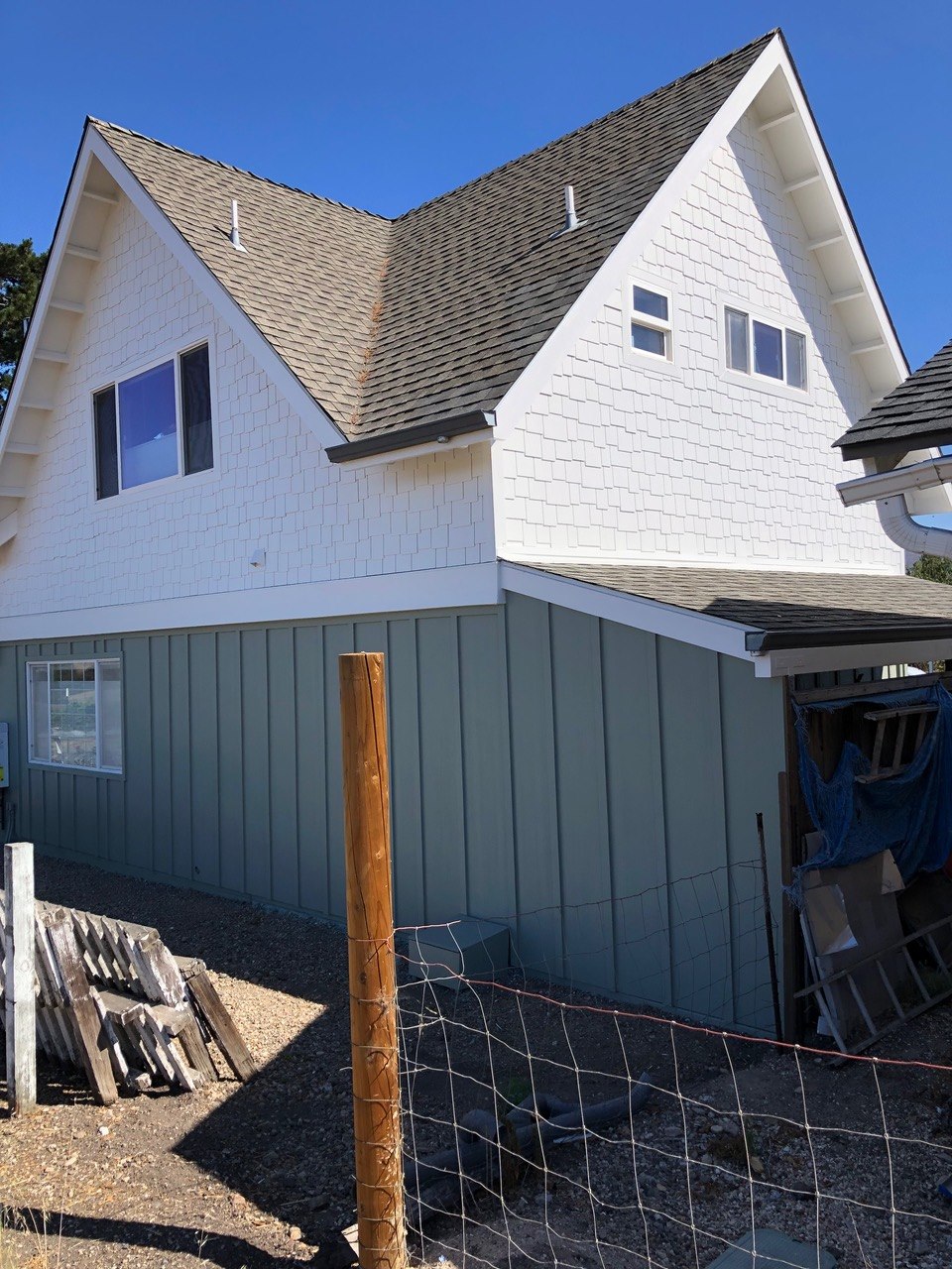 Two-story home exterior with cedar-shingle gables and board-and-batten siding