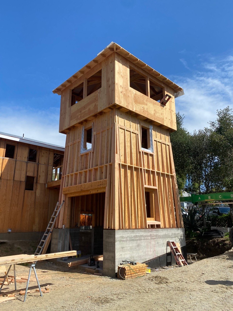 New construction three-story tower framing on a concrete foundation