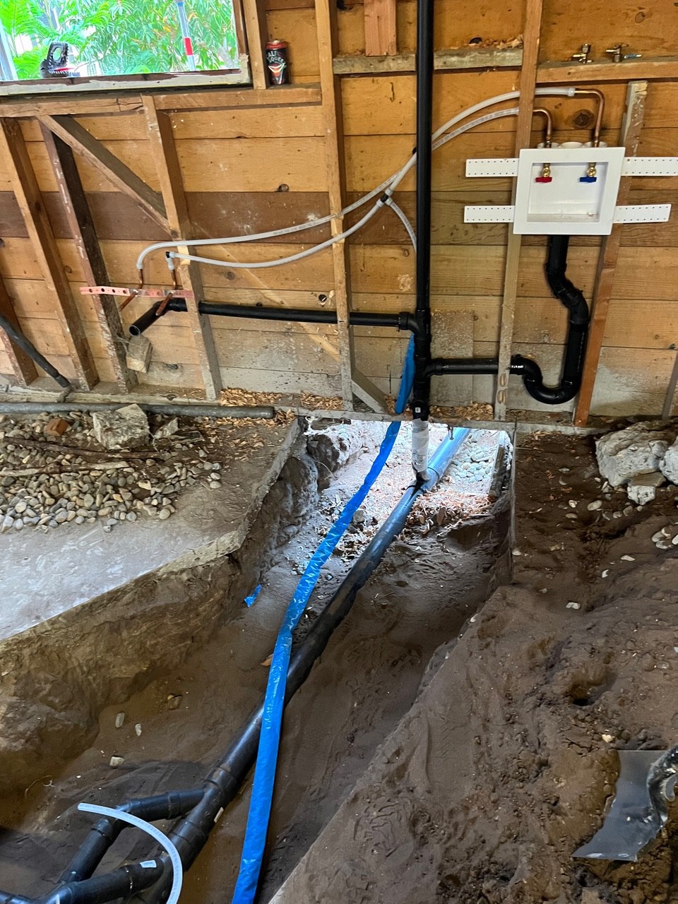 Under-floor plumbing rough-in with new supply and drain lines trenched in